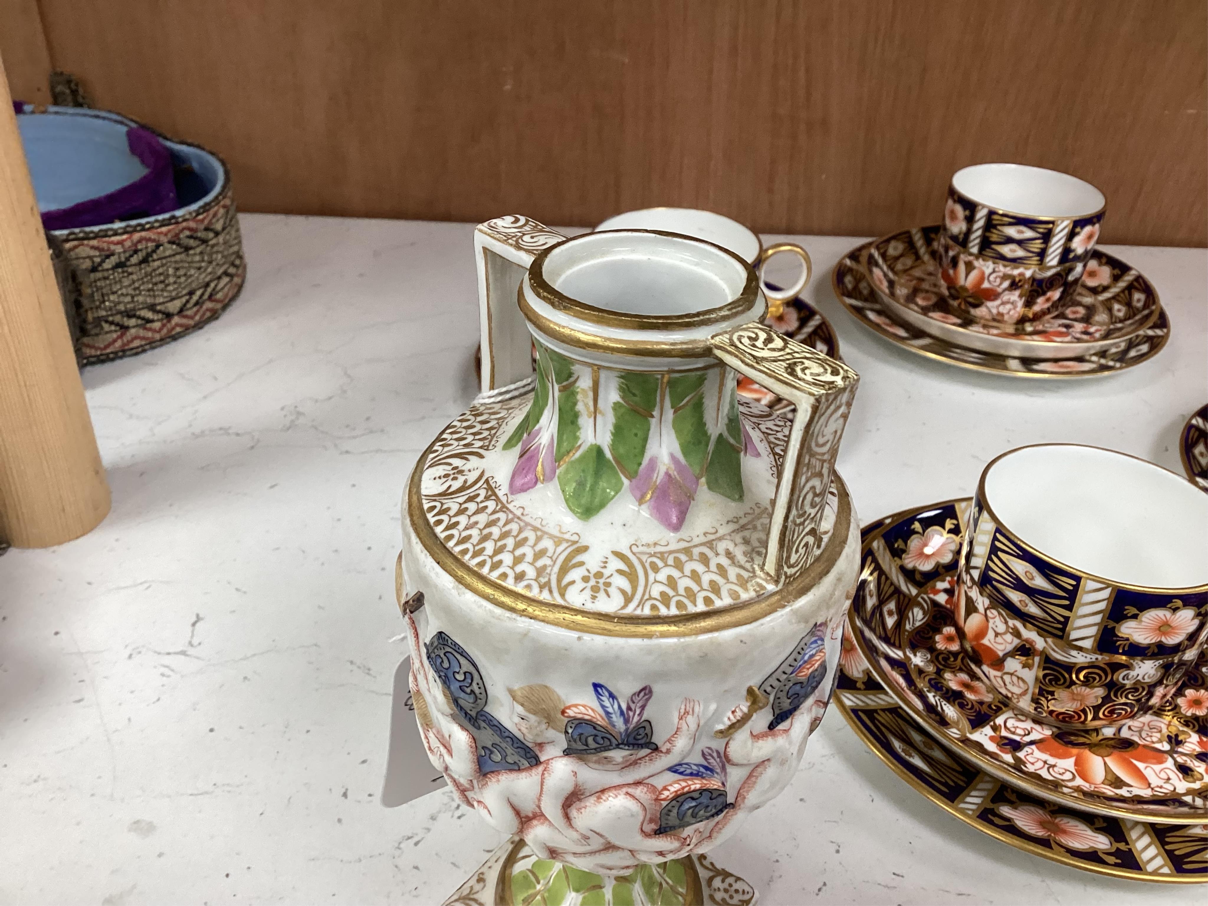 A Crown Derby Imari seven trio place setting, three other cups and two saucers, a large plate and a pair of Doccia- style vases, 18cm high